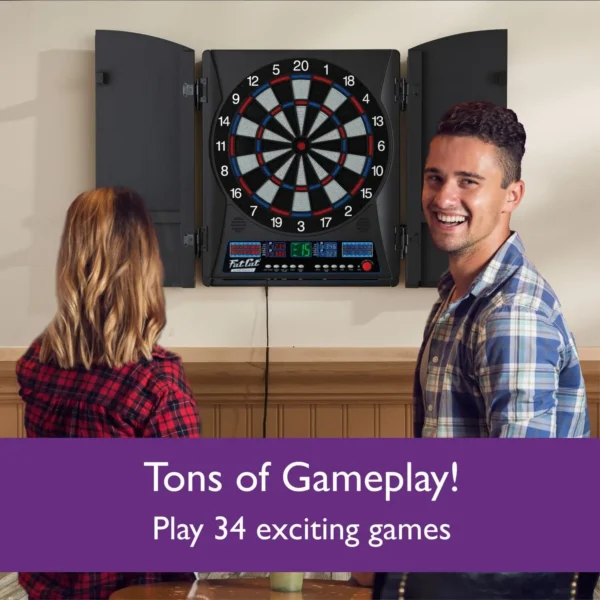 Two individuals standing in front of an electronic dartboard mounted on a wall.